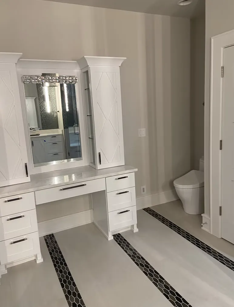 White vanity and dressing area over patterned bathroom floor tile