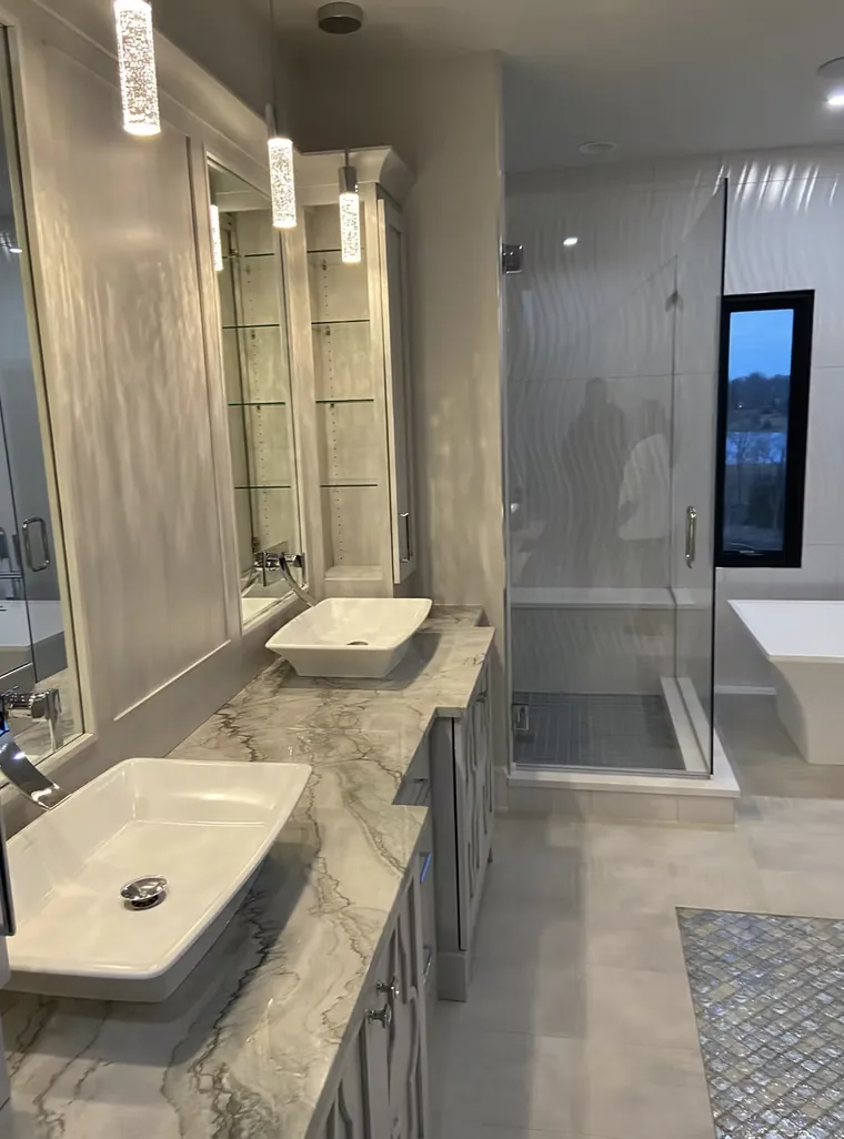 Bathroom with a stone topped vanity, vessel sink and glass shower