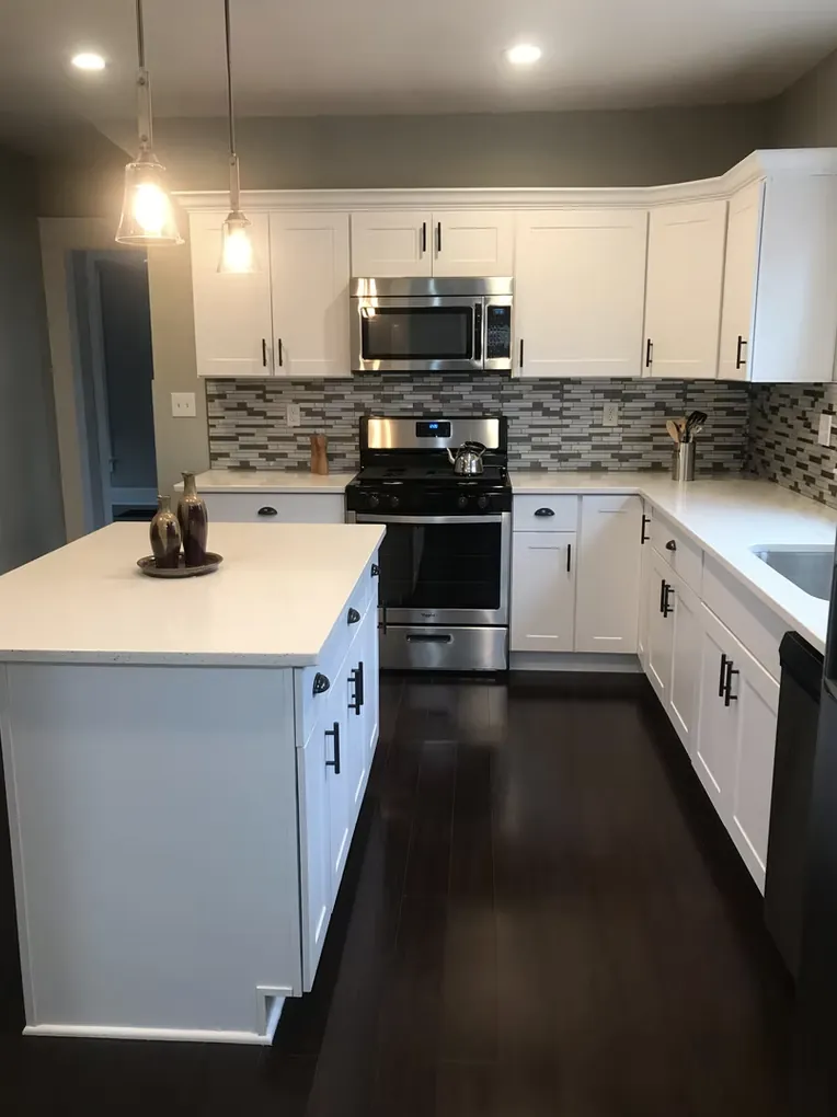 White kitchen with a peninsula, pendant lights and mosaic backsplash